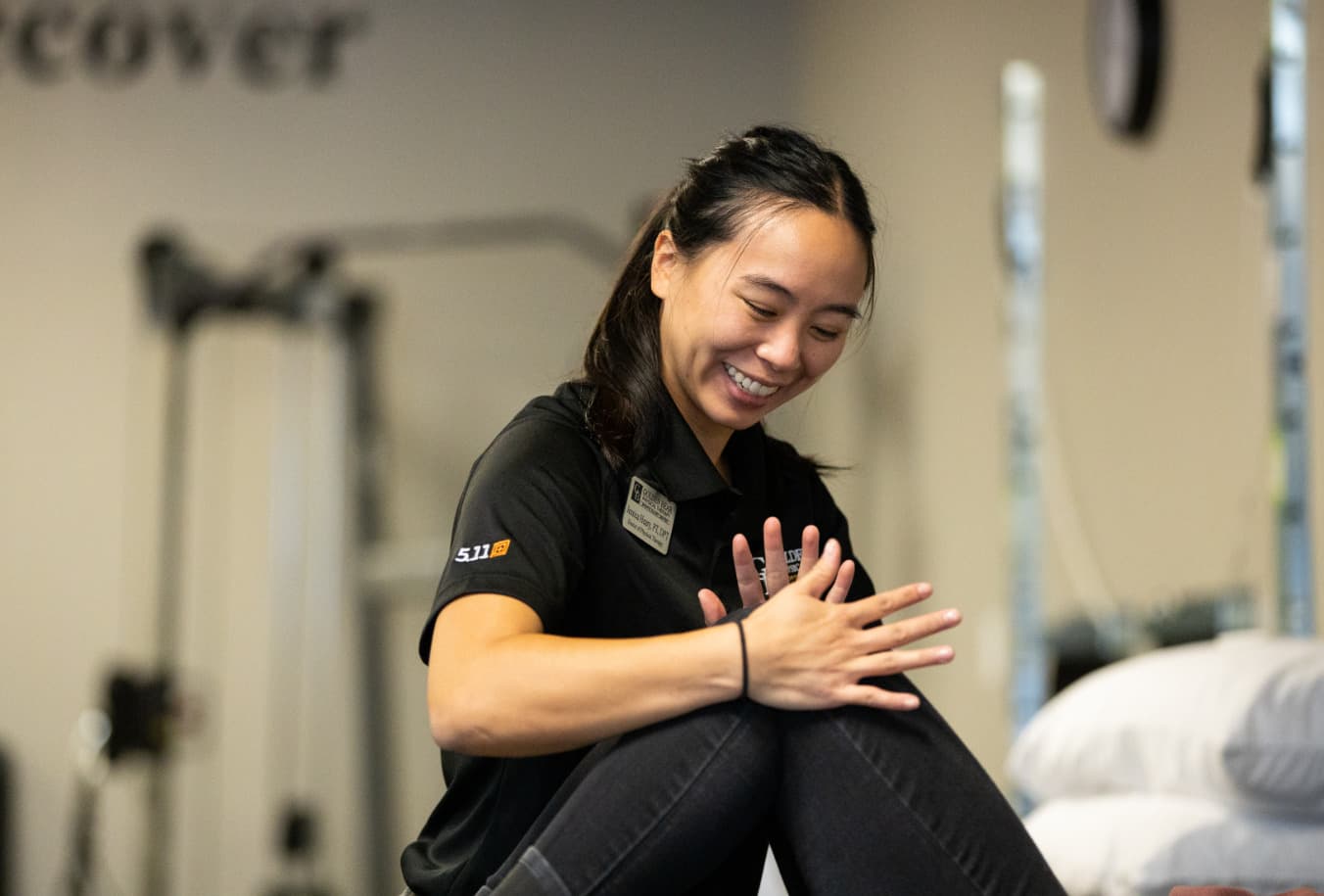 Physical Therapist Treats a patient - asian woman putting pressure on patient's knee