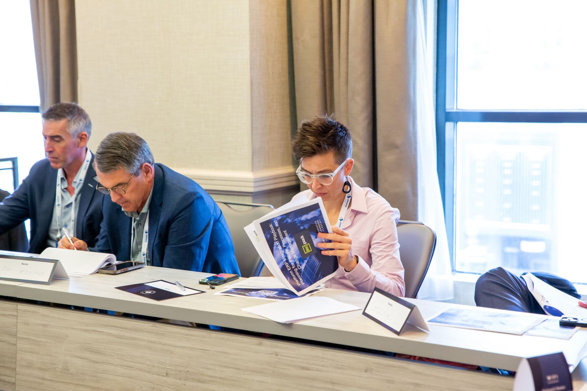 Executives review handouts during breakout session at Shore Capital Partners Executive Leadership Academy