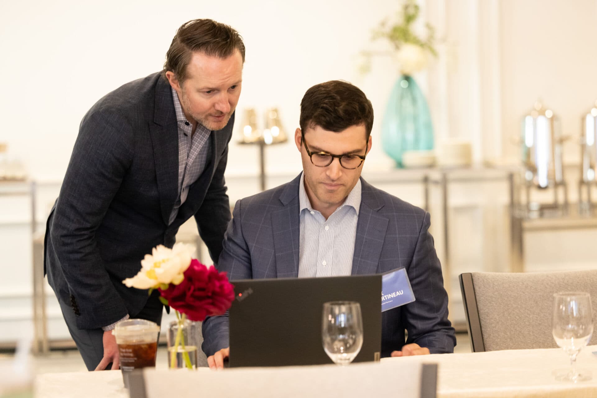 Ryan Kelley leans over a laptop in a working session with Max Martineau