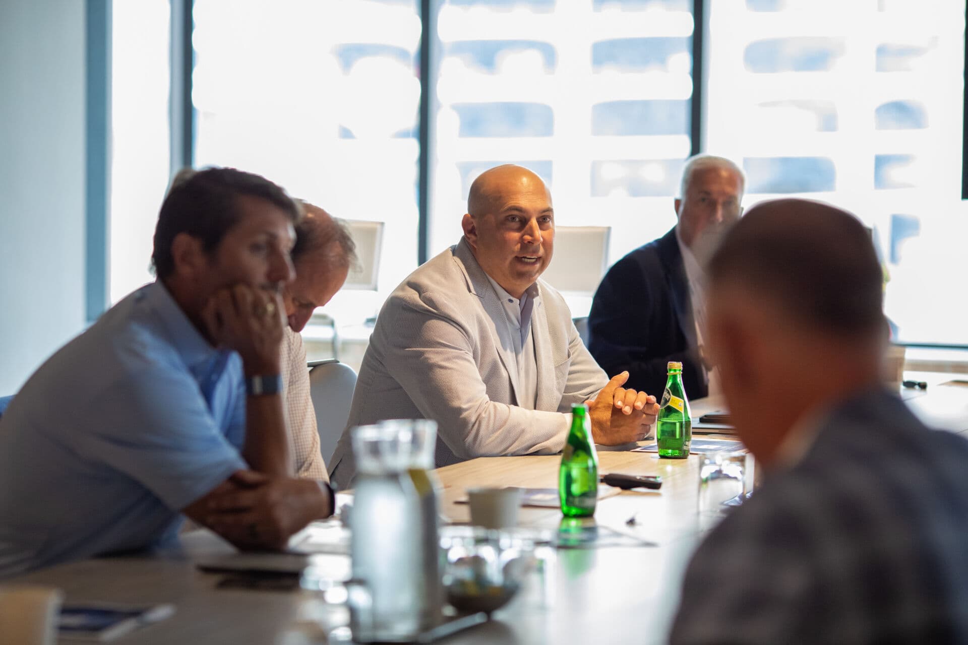 Executives seated at a conference room table